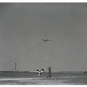 USAF F-80C piloted by Lt. Walter Rew as it crosses the finish with checkered flag, 1949.