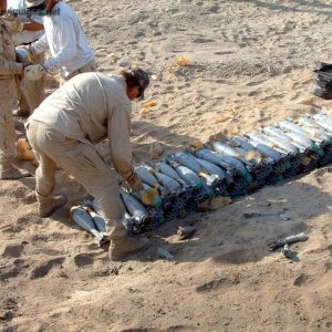 Contractor employee arranges mortars into stacks