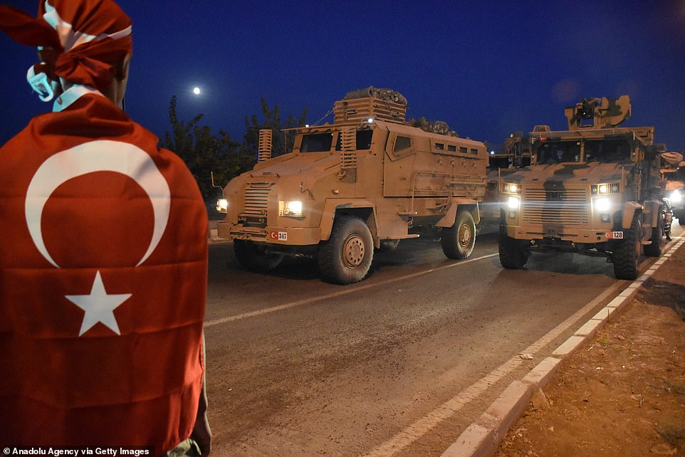 19634606-7565423-Turkish_citizens_show_their_support_as_military_vehicles_drive_t-a-19_1570921...jpg