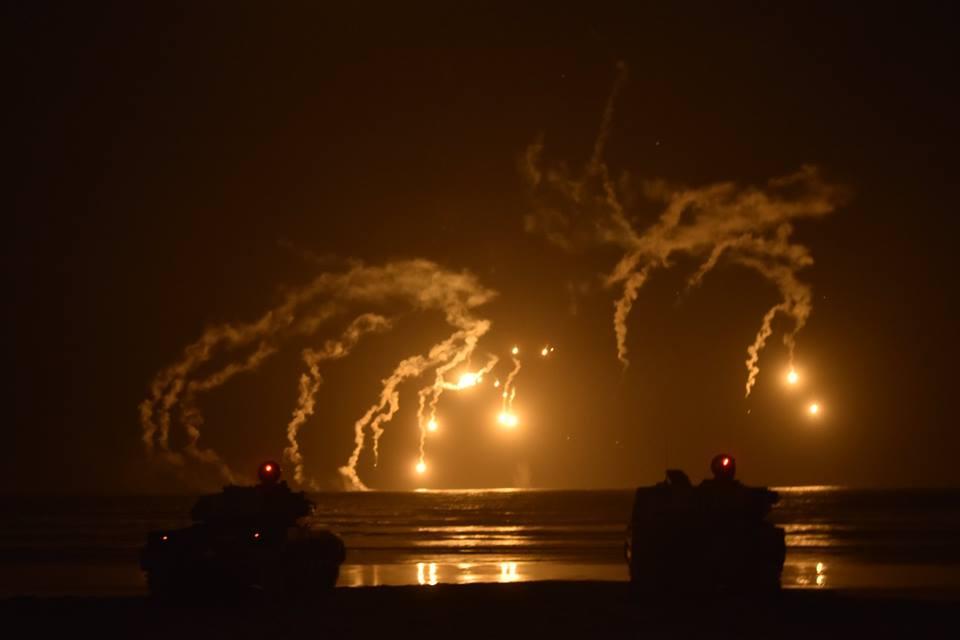 A beach defence in Cape Town, two Olifant MBTs under the lit night sky.jpg