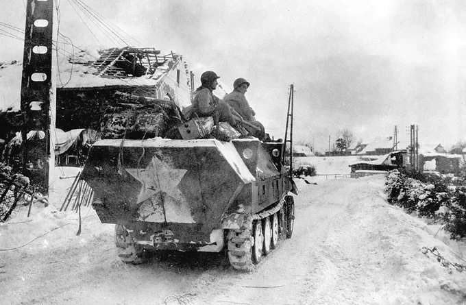 A captured German Sd.Kfz. 251 halftrack is used by troops of the US 16th Infantry Regiment to...webp