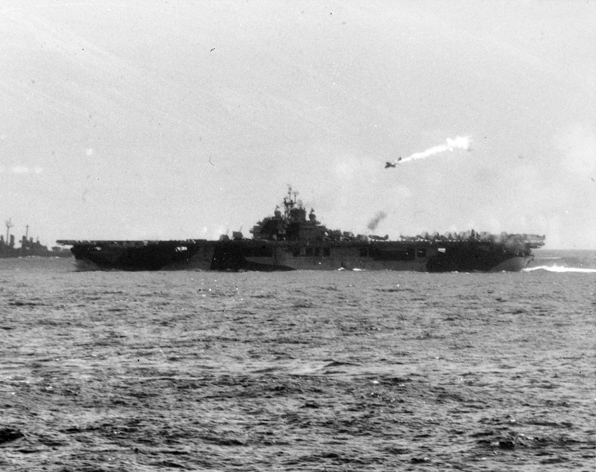 A kamikaze pictured moments before hitting the carrier Essex (CV 9) operating off the Philippi...jpg
