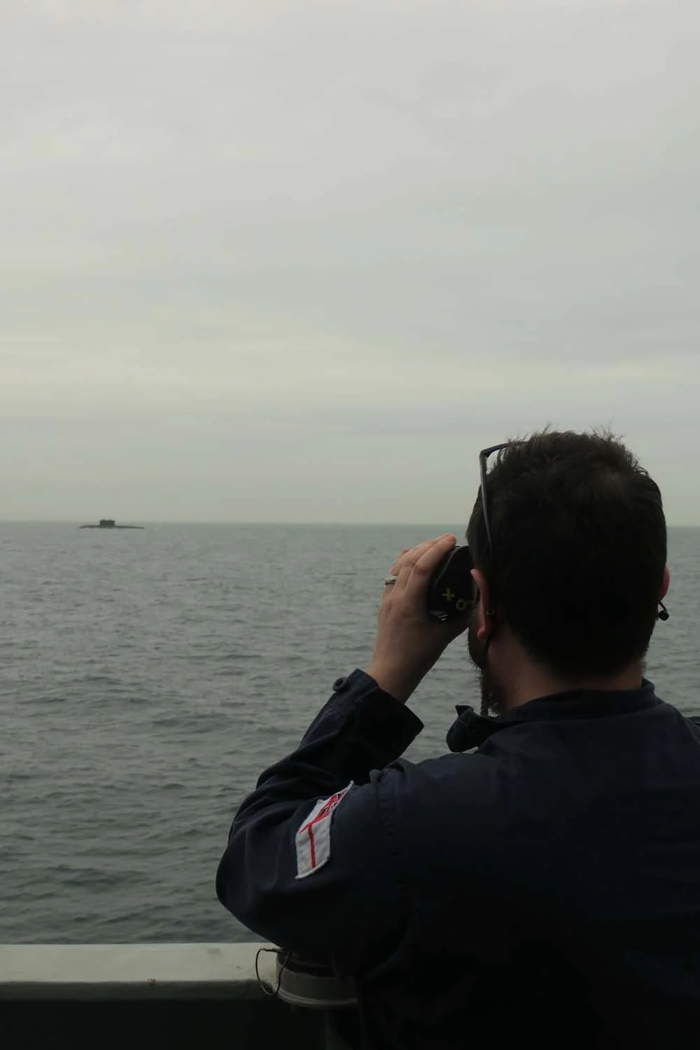 A Royal Navy sailor monitors activity.webp