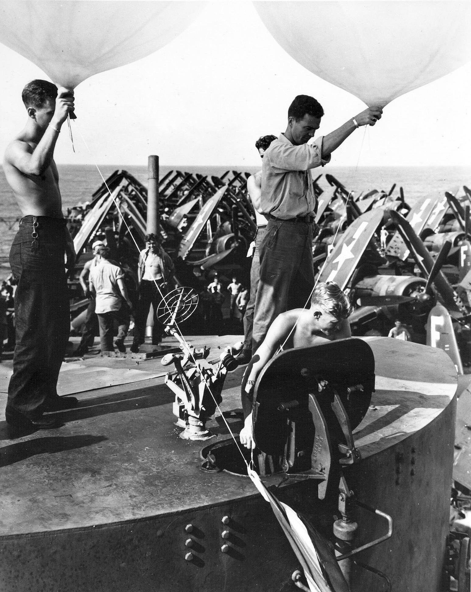 Aerographer's mates prepare to release weather balloons from the carrier Essex (CV 9) during o...jpg