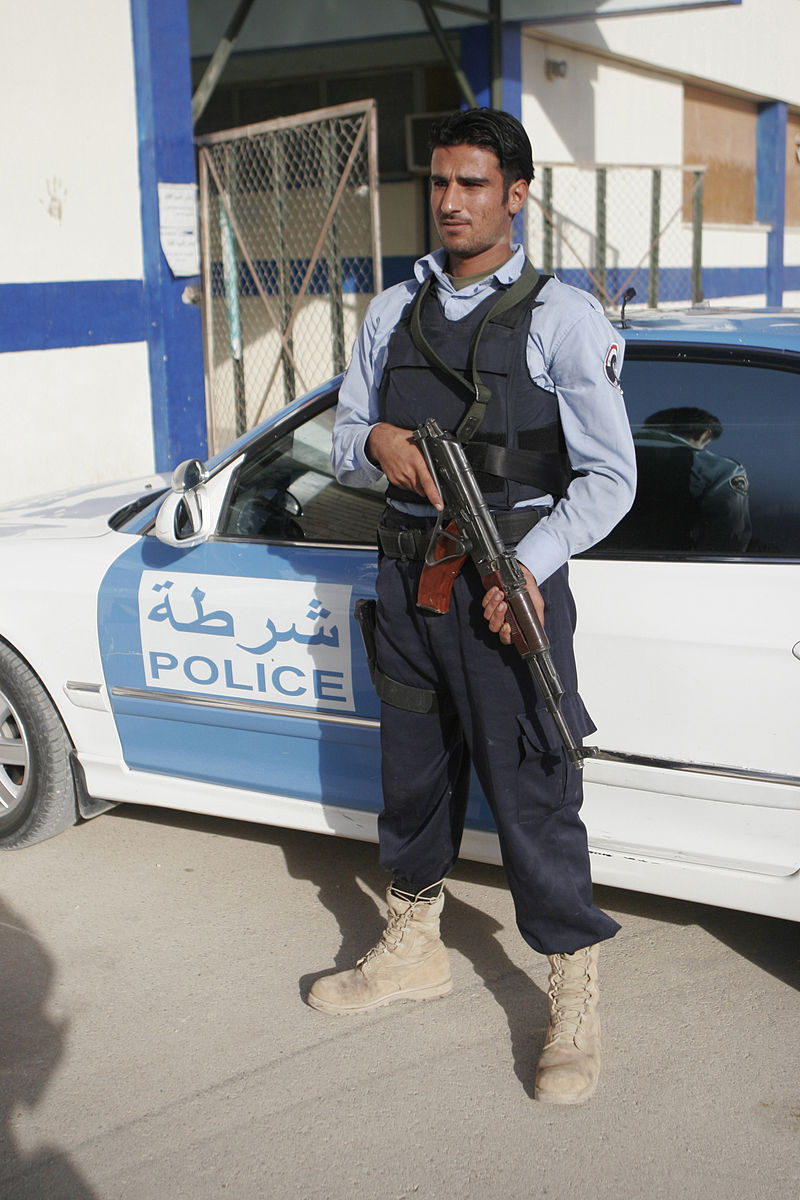 An_Iraqi_policeman_posts_as_over_watch_security_as_fellow_policemen,_not_shown,_receive_new_eq...jpg