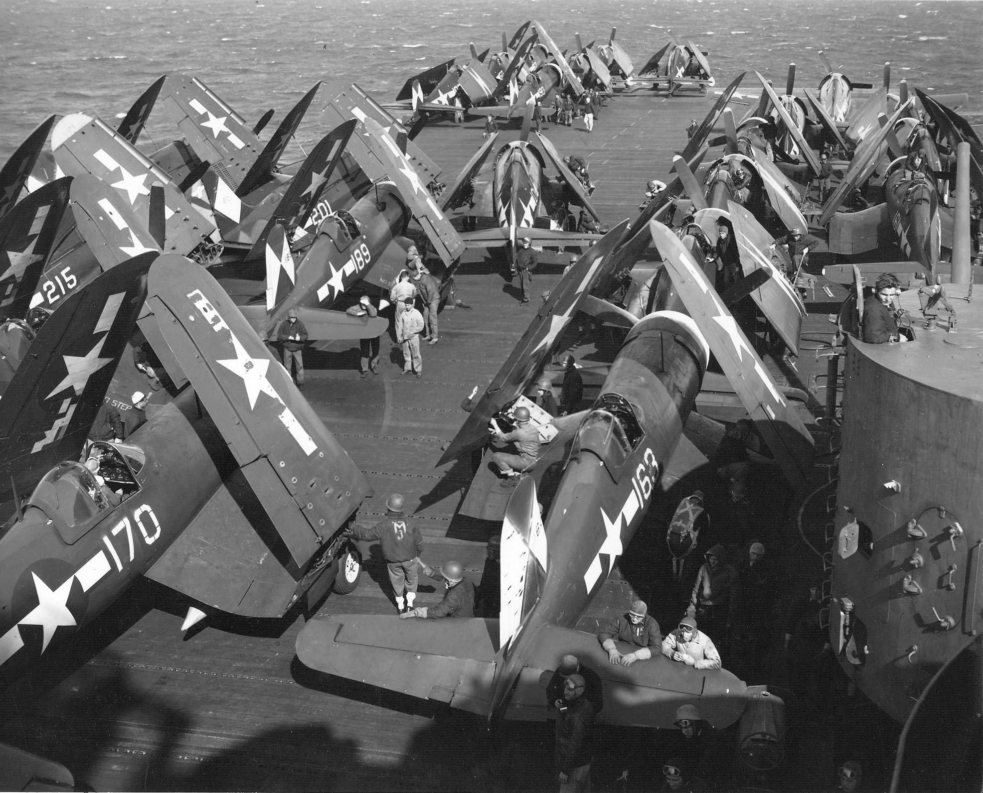 F4U Corsairs and F6F Hellcats of Air Group 83 pictured on the flight deck of the carrier Essex...jpg