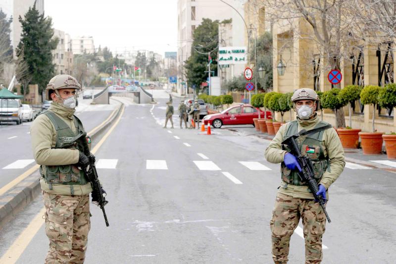 Jordanian-army-members-stand-guard-at-a-check-point-after-the-start-of-a-nationwide-curfew-ami...jpg