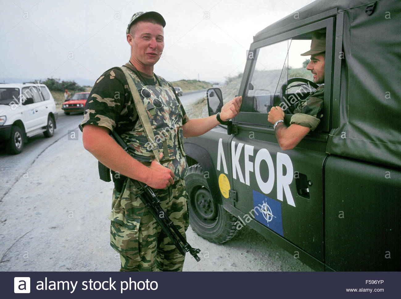 Kosovo, July 2000 Russian soldier on watch to a checkpoint on the Pristina-Pec road speaks wit...jpg