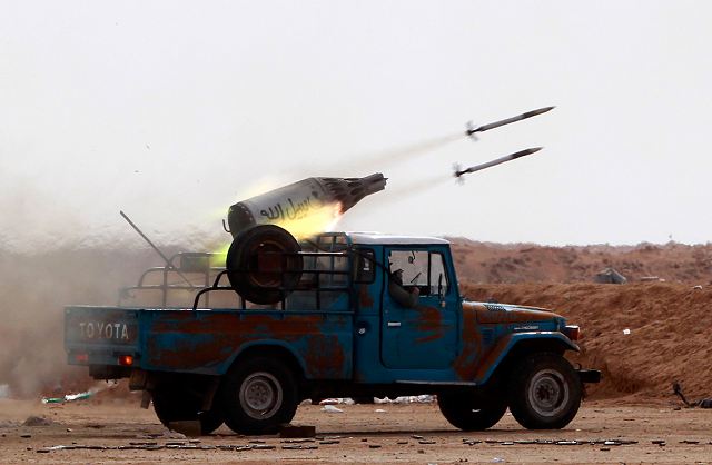 Libyan_rebel_fire_with_UB-32_57mm_helicopter_rocket_launcher_pod_mounted_on_light_pickup_truck...jpg