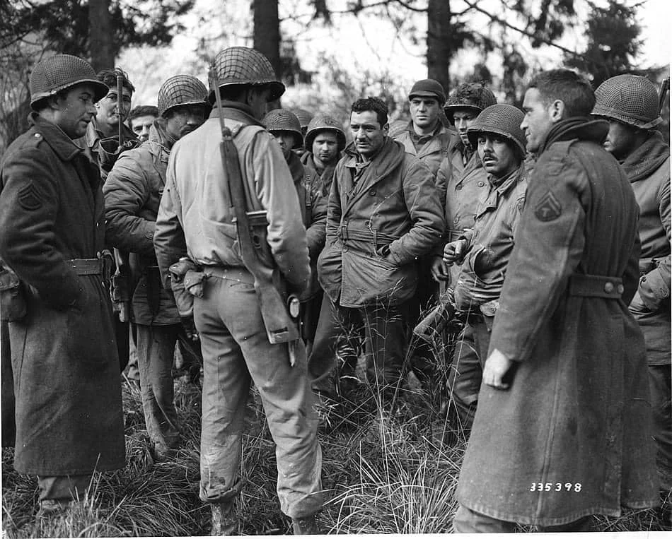 Members of the 28th Division Band and Quartermaster Company who stayed and held Germans in Wi...webp