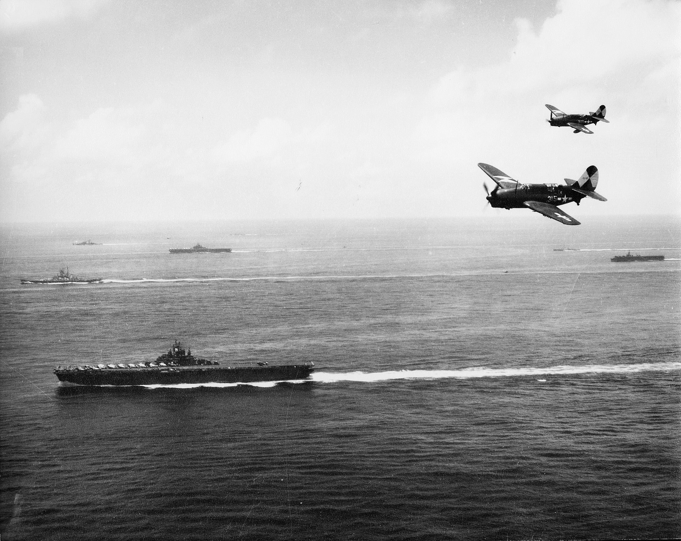 SB2C-4's of VB-83 with task group 38.3 off Okinawa with  ESSEX in foreground March-Sept 1945.jpg