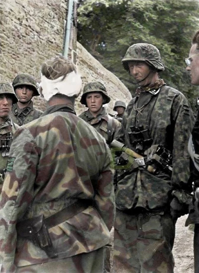 SS-Obersturmbannführer Max Wünsche (with the bandaged head), Rgt. Komm. of SS-PzRgt 12 visiti...webp