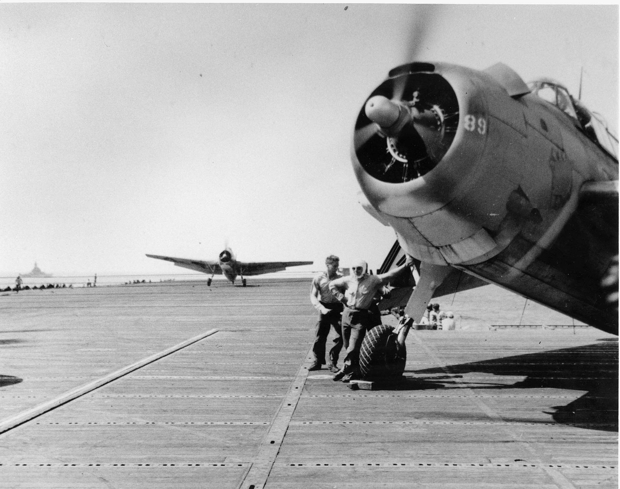 TBM-1C Avenger, with Torpedo Squadron Eighty-Three (VT-83) sitting on the deck of a carrier, p...jpg