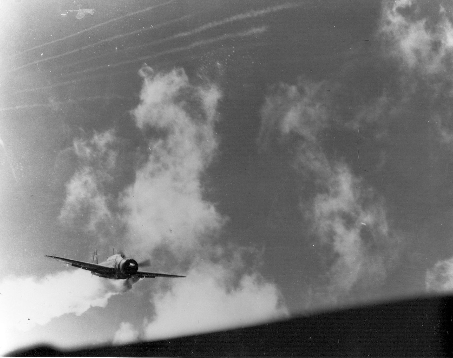 View of a Japanese kamikaze plane, smoking from antiaircraft hits, moments before slamming int...jpg