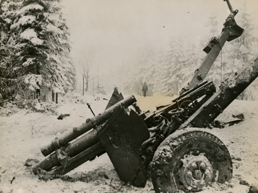 Wrecked 105mm howitzer near Manhay Belgium.jpg
