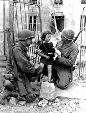 Two American soldiers comfort an upset girl with a puppy, 1944.webp