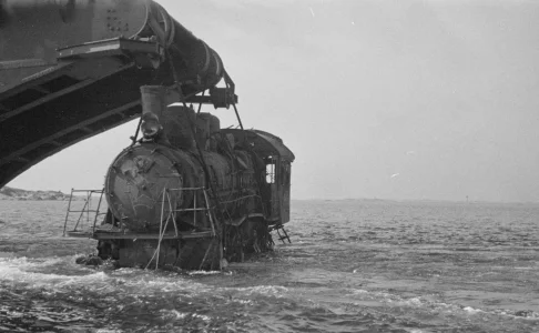 barge lifts a wrecked locomotive.webp