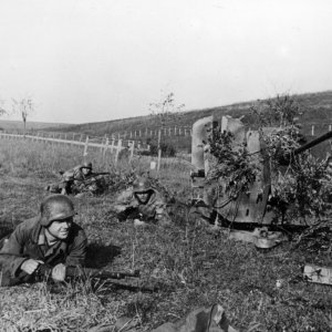 The Crew Of A 20mm Flak 38 Lay Prone Around Their Gun