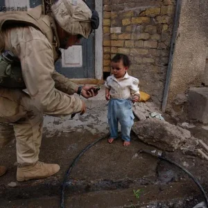 U.S. Marine offers a cookie during a patrol