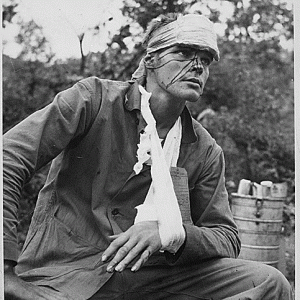 A Wounded U.S. Marine Awaiting Transportation Back To A Fiel