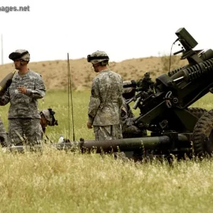 Staff Sgt. receives a 105mm round for an M119A2