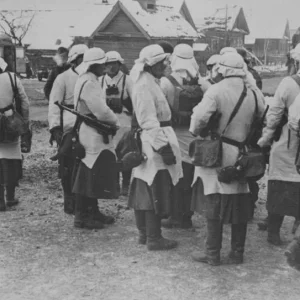 A group of German soldiers after the receipt of their winter camouflage on a street of a village near Moscow