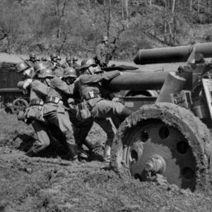 German soldiers attempting to push a heavy howitzer out of the mud