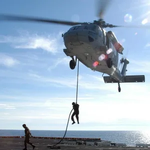 Sailors conduct fast rope exercises from a MH-60S