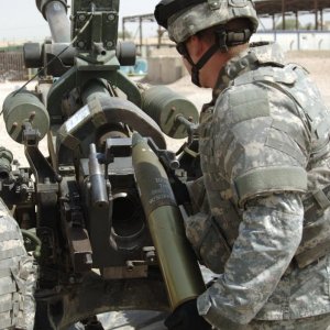 U.S. Army Pfc. Odell loads a round into M119-A2