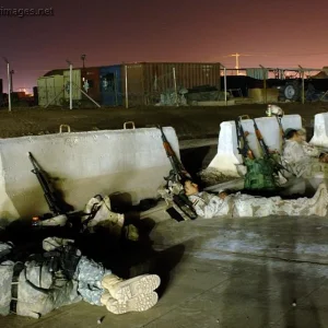U.S. Army and Iraqi army soldiers rest on the tarmac