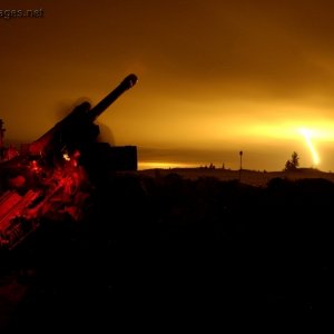C3 105mm Howitzer fires an illumination round
