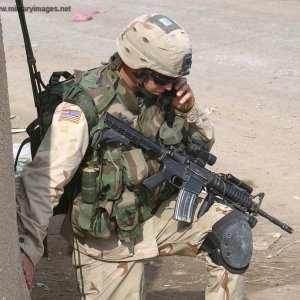 Paratrooper communicates through a tactical radio