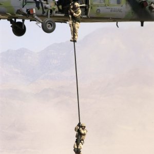Airmen rappel from their HH-60 Pave Hawk helicopter