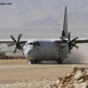 Australian C130J-30 Hercules lands on a dirt airstrip