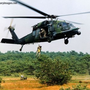 An older MH-60G hoisting a soldier