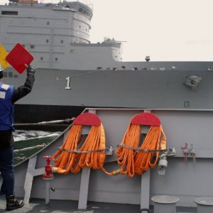 Seaman signals to the Argentine supply ship