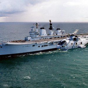 Merlin helicopter flying past HMS Ark Royal