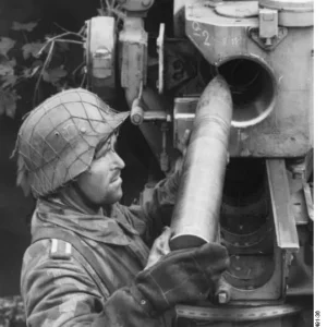 German soldier loading a shell into an 8.8 cm FlaK gun, France, 1944
