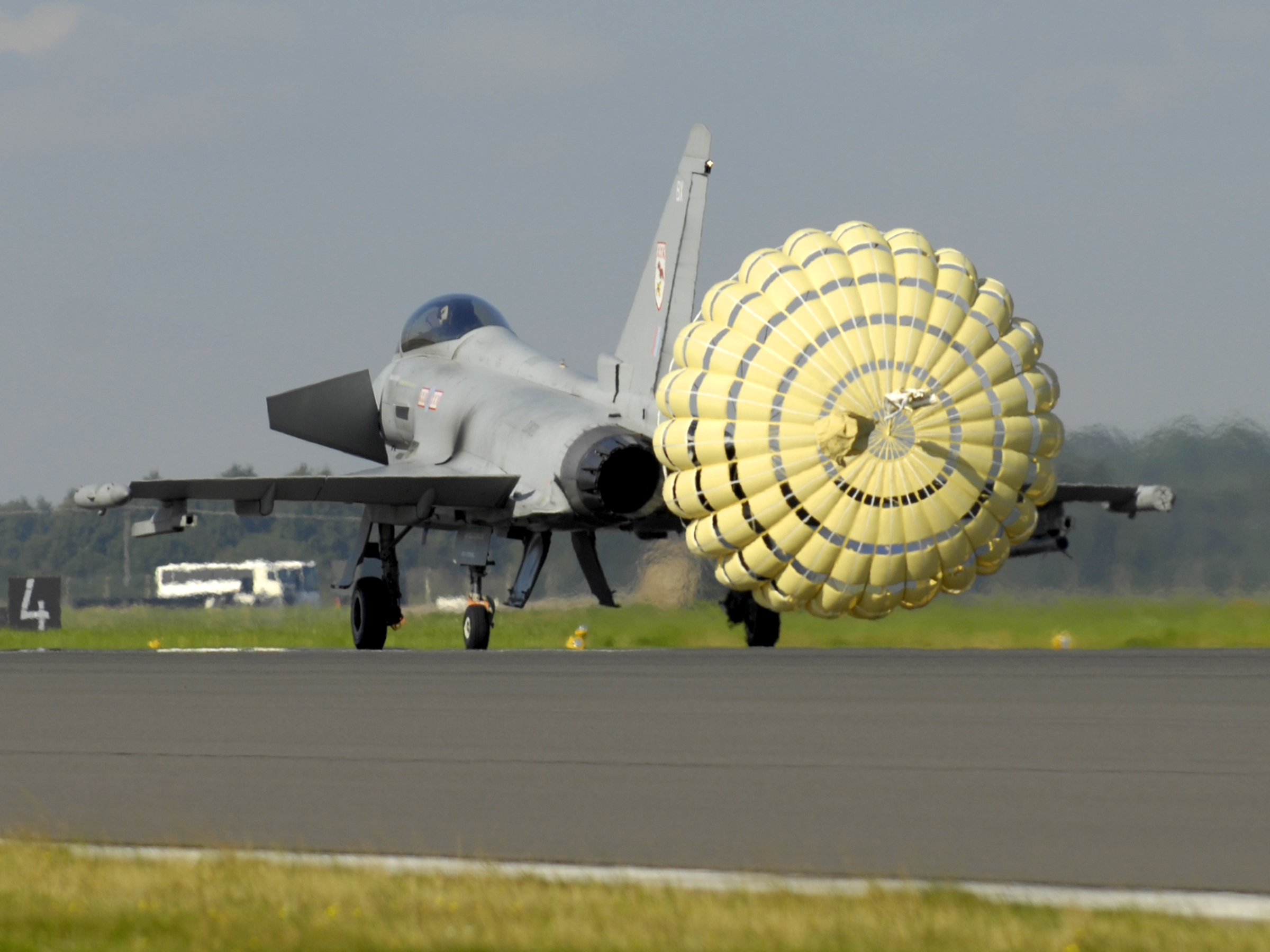 A_Typhoon_F2_fighter_jet_deploys_a_brake_parachute_as_it_lands_at_RAF_Coningsby_MOD_45147966.jpg