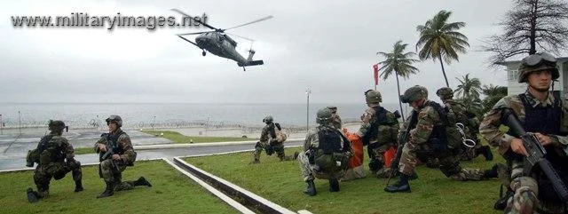 Army troops wait on a blackhawk