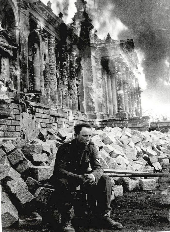 German soldier sitting in front of the burning Reichstag (1945)