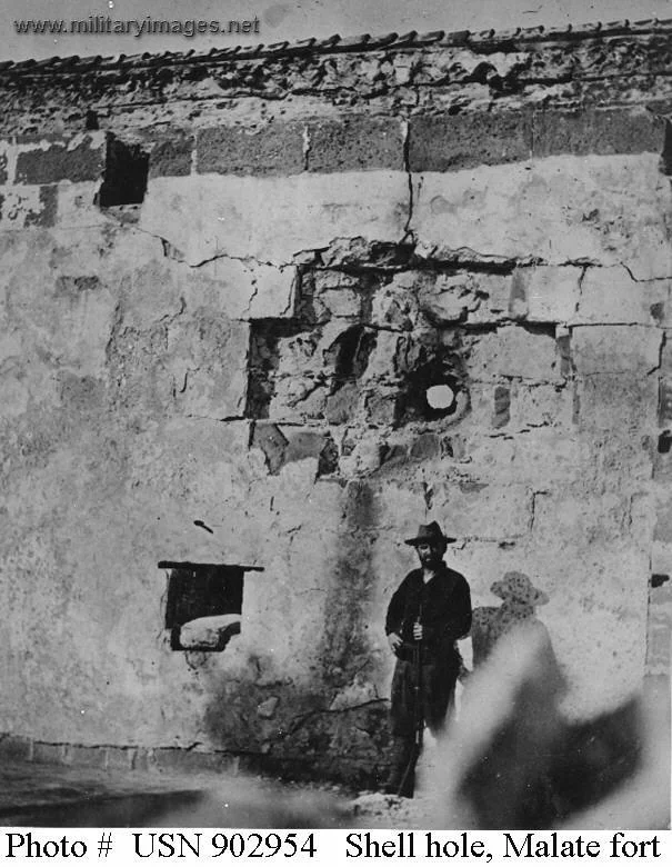 Sentry poses before a shell hole in the fort