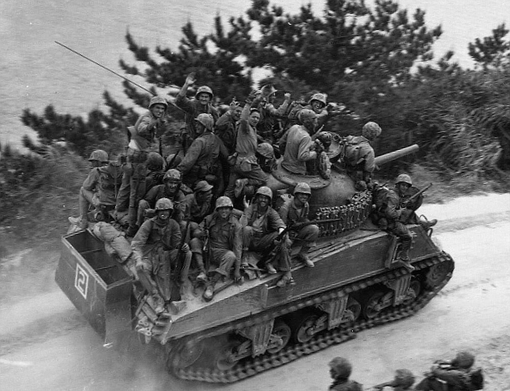 Sherman tank carrying passengers