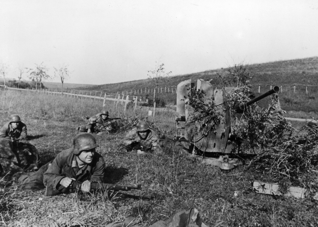 The Crew Of A 20mm Flak 38 Lay Prone Around Their Gun